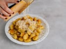Cooking Class - Gnocchi Two Delicious Ways in Atlanta: grating Parmesan cheese over gnocchi