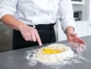 Cooking Class - Make Fettuccine With Creamy Alfredo in East Bay: preparing fresh pasta dough with Cozymeal apron on