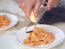 Cooking Class - Homemade Fettuccine and Fresh Marinara in Indianapolis: grating Parmesan cheese over marinara soaked pasta plate