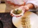 Team Building Cooking Class - Make Dumplings With Your Crew - Washington D.C.: folding dumplings in Cozymeal apron
