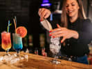 Cooking Class - Craft Perfect Ice Cream Cocktails - Queens in Manhattan: adding ice into a glass and mixing colorful cocktails