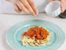Cooking Class - Pasta From Scratch in Charlotte: seasoning fettuccine pasta with marinara sauce