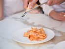 Team Building Cooking Class - Crafting Pasta as a Group in DC: grating cheese over tagliatelle