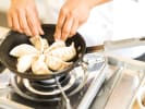 Cooking Class - Make Dumplings From Scratch at a Local Brewery: cooking gyoza dumplings in a pan