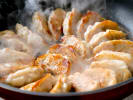 Cooking Class - Handmade Potstickers and Sushi: cooking gyoza dumplings in a pan
