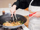 Cooking Class - Thai Flavors For All: cooking pad thai in a wok pan