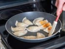 Online Cooking Class - Gyoza Dumplings From Scratch: cooking potstickers in a pan