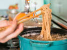 Cooking Class - Restaurant-Style Ramen Cooking in Northern Suburbs: cooking handmade ramen noodles in a blue pot