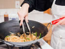 Cooking Class - Thai Flavor Night - Family Fun in Northern Virginia: cooking pad Thai in a wok pan