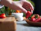 Cooking Class - Sweet Summer Flavors in Downtown Dallas: chef placing fresh strawberry slices onto dessert in kitchen