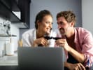 Online Couples Cooking Class - Heart Healthy Seafood Feast: couple drinking wine during an online cooking class