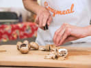 Cooking Class - Unforgettable French Spread: cutting mushrooms in Cozymeal apron