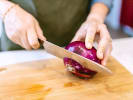 Cooking Class - Craft an Ethiopian and Eritrean Feast: cutting red onions for sald