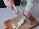 Cooking Class - Parisian Plates and Recipes in Westchester, NY: chef slicing fresh leeks on wooden cutting board