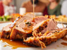 Cooking Class - Rustic Spanish Favorites in Northern Virginia: drizzling sauce over plated roasted pork loin slices