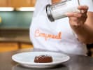 Cooking Class - Craft French Chocolate Cake in Downtown Dallas: dusting chocolate lava cake with icing sugar