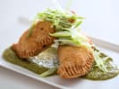 Cooking Class - Argentinian Empanada Classics in Boulder: empanadas plated with Chimichurri sauce