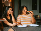 Food Tour - Walk & Taste Your Way Through Minneapolis in Minneapolis: laughing while eating pizza slice together