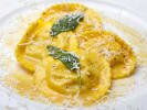 Cooking Class - Make Ravioli & Tagliatelle at a Wine Bar in Minneapolis: fresh ravioli pasta on a plate with Parmesan and sage garnish