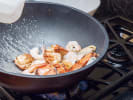 Cooking Class - Culinary Journey to Asia: frying shrimp in cast iron pan