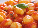 Cooking Class - Handmade Potato Gnocchi From Scratch in Hollywood Area: gnocchi plated with tomato sauce and basil garnish up close