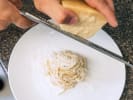 Cooking Class - Make Ravioli & Tagliatelle at a Craft Winery & Cider House in Minneapolis: grating Parmesan cheese on cacio e pepe pasta