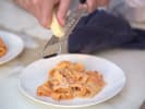 Cooking Class - Restaurant-Quality Pasta in San Fernando Valley: grating Parmesan cheese over tagliatelle with marinara sauce