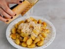 Cooking Class - Craft Sicilian Pasta by Hand in Culver City: grating cheese over gnocchi