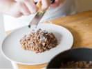 Team Building Cooking Class - Exploring Tuscan Cuisine in Toronto: grating cheese over mushroom risotto
