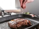 Cooking Class - Steakhouse Classics: grilling steak and seasoning it with salt