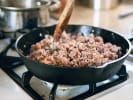 Couples Cooking Class - Authentic New Orleans Cooking: ground beef frying in a cast iron skillet