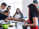 Team Building Cooking Class - Battle of the Dips: group making salsa together and seasoning ingredients