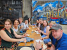 Food Tour - Exploring Bustling Buckman in Portland, OR: group of people eating on a Protland food tour stop