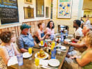 Food Tour - Garden District Food and Cemetery Tour in New Orleans: group of tourists eating together