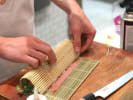 Cooking Class - Sushi Rolls at the Infinity Towers in San Francisco: guest rolling sushi roll