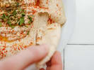 Cooking Class - Traditional Tapas: hand scooping up hummus with pita bread