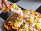 Food Tour - NYC's Iconic Pizza Slices in Manhattan: holding pizza by the slice