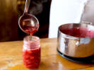 Online Couples Cooking Class - Classic Homemade Jam: ladeling homemade strawberry jam into a jar