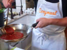 Team Building Cooking Class - Italian Pasta Culinary Challenge: making tomato sauce with Cozymeal apron on