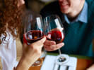 Virtual Wine Tasting - A Tour Through Mediterranean Wines: man and woman cheersing with red wine
