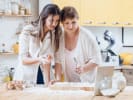 Online Cooking Class - Basic Techniques of French Baking: mother and daughter baking and looking at computer
