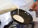 Online Italian Cooking Class - Homemade Cannelloni and Panna Cotta: chef pouring crepe batter into a pan