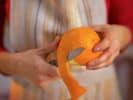 Online Mixology Class - Demystifying Mezcal Cocktails: person peeling an orange