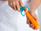 Cooking Class - Fresh Market Flavors: peeling a carrot in a cooking class