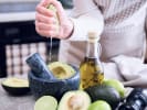 Team Building Cooking Class - Handmade Guacamole Competition: person adding fresh lime to guacamole