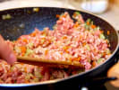 Cooking Class - Secrets of Pasta Making: person cooking bolognese sauce