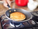 Online Couples Cooking Class - Pancakes and Mimosas Pajama Brunch: person cooking lemon ricotta pancakes