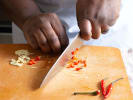 Cooking Class - Gluten-Free Popular Thai Street Food in Boston Proper: person dicing thai chilis