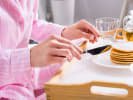 Online Couples Cooking Class - Pancakes and Mimosas Pajama Brunch: person eating pancakes in pajames