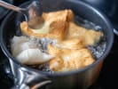 Online Cooking Class - Handmade Donuts 101: person frying beignets